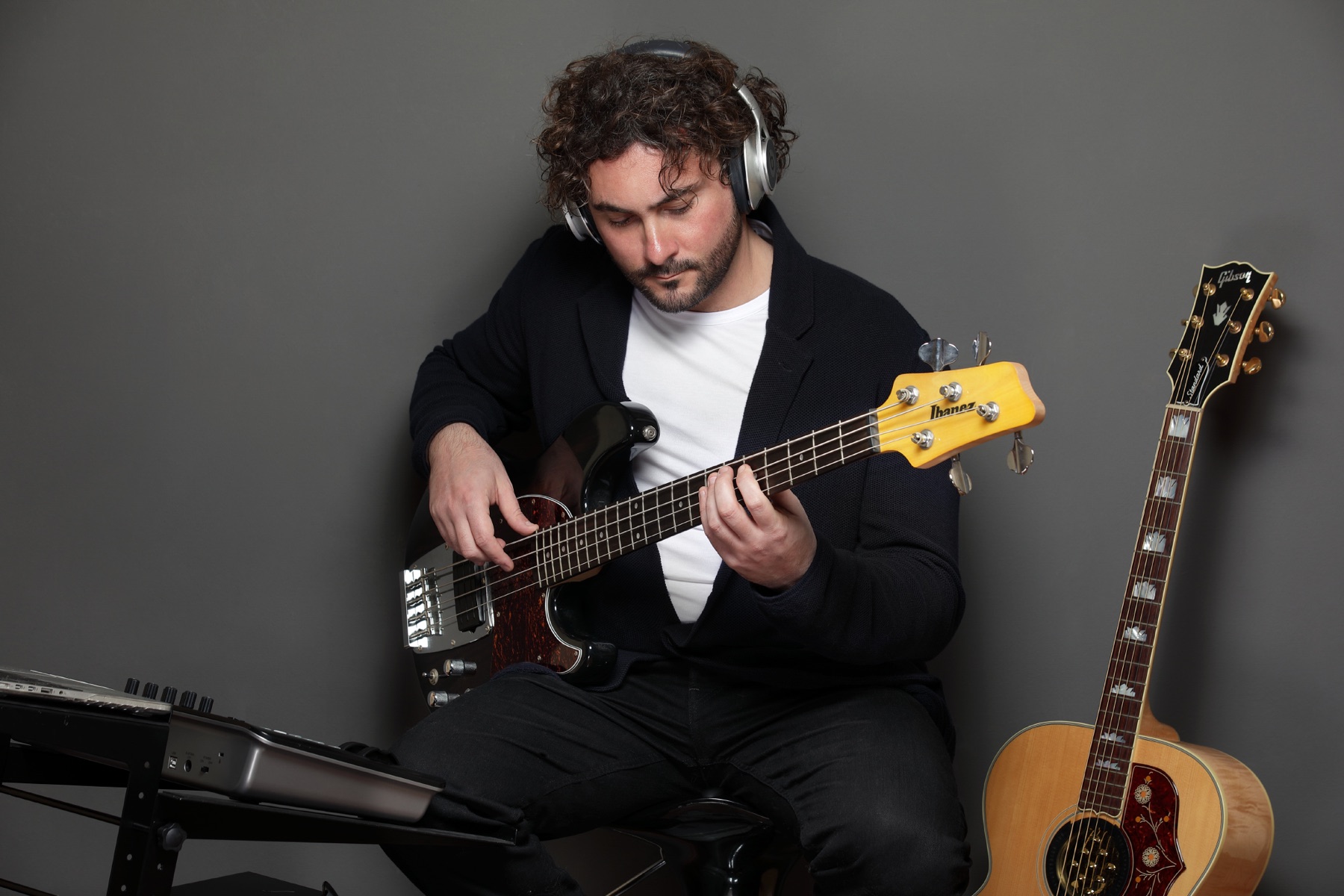 Stefano Eliamo playing bass with headphones