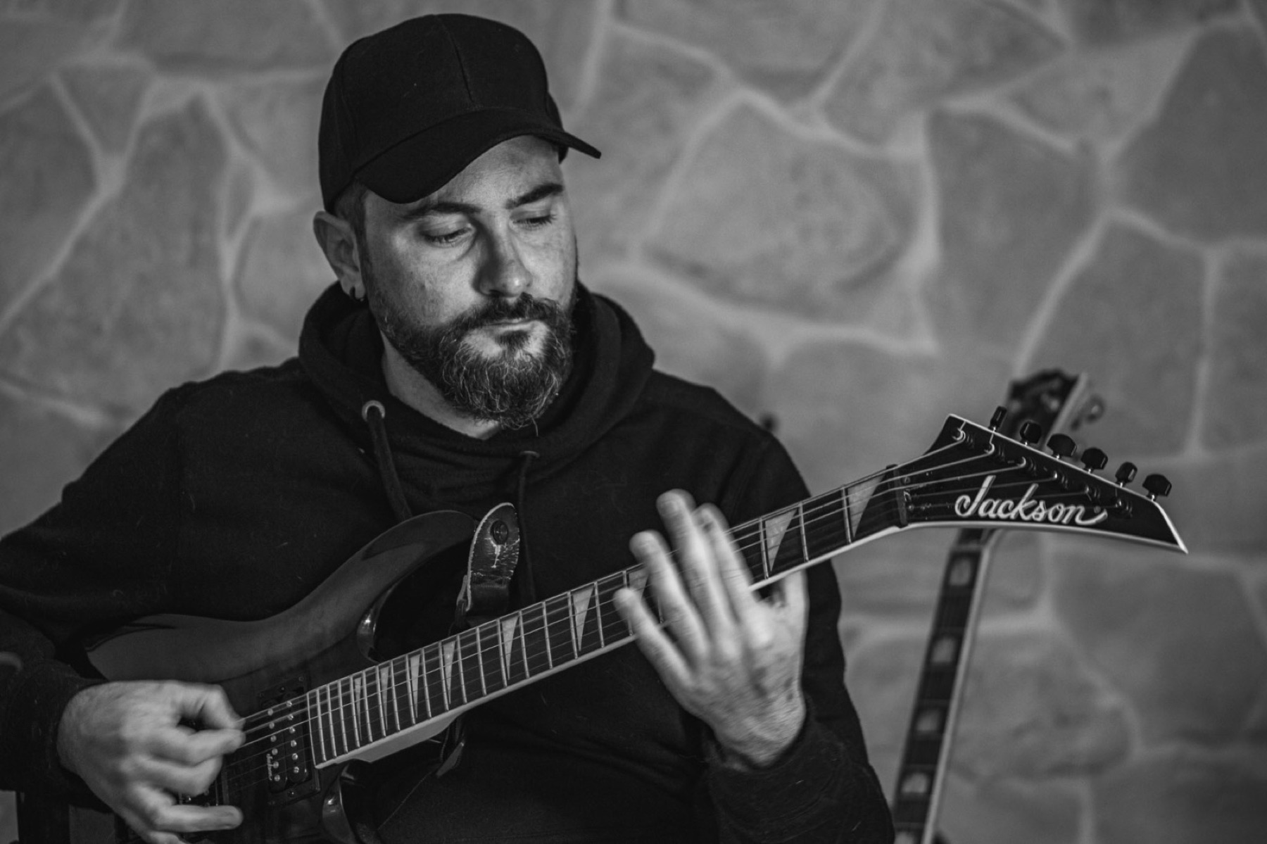 Stefano Eliamo playing electric guitar in black and white