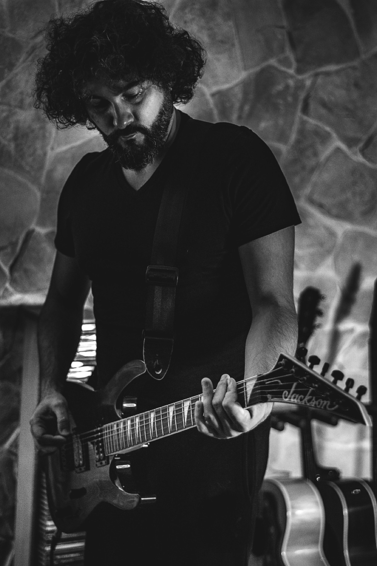 Stefano Eliamo holding an electric guitar in black and white